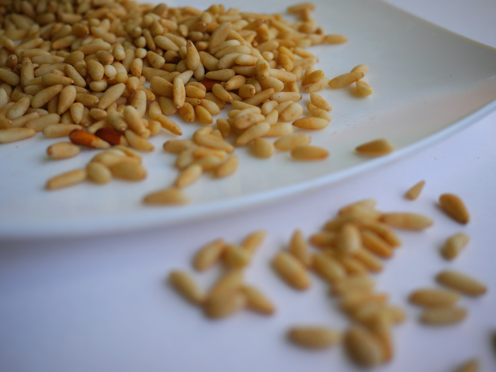 brown peanuts on white ceramic plate