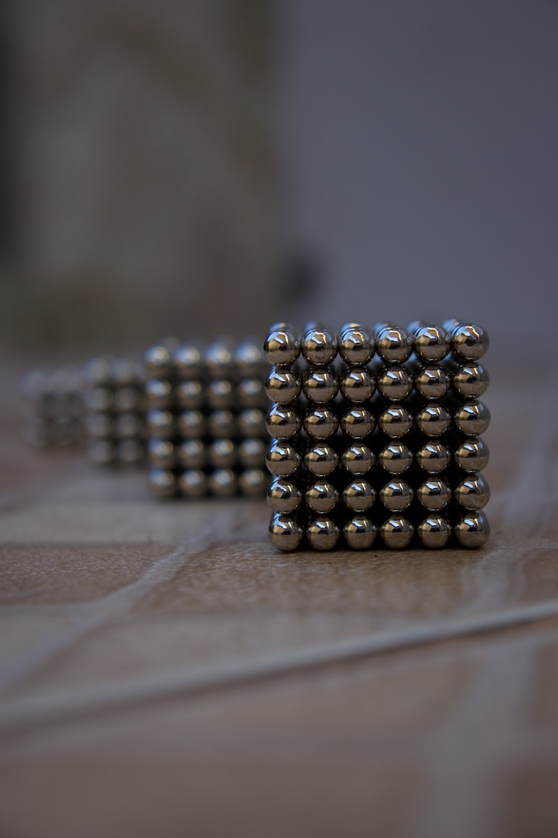 silver beads on brown wooden table