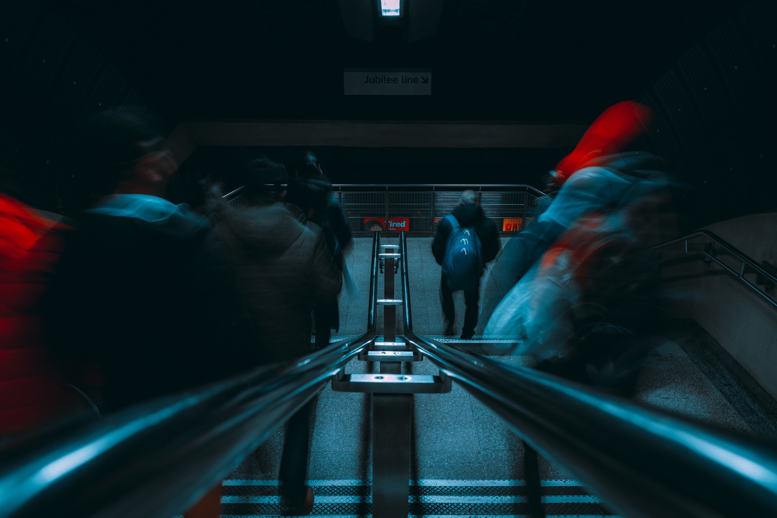 a group of people on a escalator